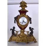 A LARGE ORMOLU MOUNTED ROUGE PORCELAIN CLOCK, formed with lion mask handles and seated cherubs. 54