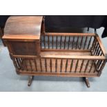 AN ANTIQUE CRIB, formed with turned railings. 102 cm x 44 cm.