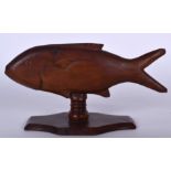 AN ANTIQUE PITCAIRN ISLAND CARVED WOODEN FISH, mounted upon a lobed plinth. 23.5 cm wide.