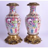 A PAIR OF 19TH CENTURY CHINESE FAMILLE ROSE VASES painted with figures, French bronze mounts. 32 cm
