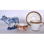 AN EARLY 20TH CENTURY PORCELAIN MOUSTACHE CUP AND SAUCER, together with a Delft pottery cow and a S