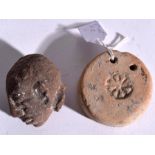 AN ANTIQUITY STONE PEDANT POSSIBLY MESOPOTAMIA, together with a stone head. 5.5 cm and 5.5 cm. (2)