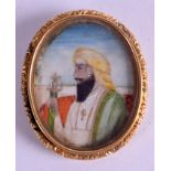 AN EARLY 20TH CENTURY GOLD MOUNTED INDIAN IVORY PORTRAIT MINIATURE, painted with a male holding a t