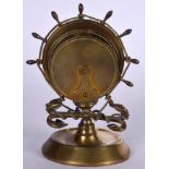 A CAPTAINS BRASS SHIPS WHEEL CARD HOLDER, formed with twin anchors. 18.5 cm high.