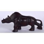 A CHINESE CARVED HARDWOOD FIGURE OF A RHINOCEROS, possibly Qing. 28 cm wide.