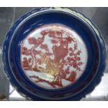 A CHINESE QING DYNASTY BLUE GROUND PORCELAIN DISH BEARING XUANDE MARKS, painted with iron red folia