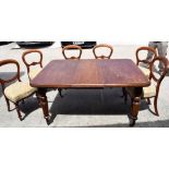 A VICTORIAN MAHOGANY DINING TABLE, three leaf on reeded legs, together with six dining chairs. 74 c