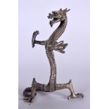 A 20TH CENTURY WHITE METAL FIGURE OF A DRAGON, formed standing, possibly a bookend. 22 cm high.