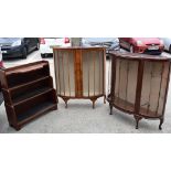 AN ANTIQUE DISPLAY CABINET DECORATED WITH GILT FOLIAGE, together with another similar and an oak bo