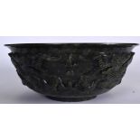 A HUGE CHINESE SPINICH JADE BOWL, carved with opposing dragons in pursuit of the flaming pearl. 30.