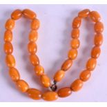 AN AMBER BEAD NECKLACE. 36 cm total length & weight 20 grams.