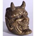 A HEAVY BRASS INKWELL OF SATANIC INTEREST IN THE FORM OF A DEVIL HEAD, modelled grinning. 10.5 cm h