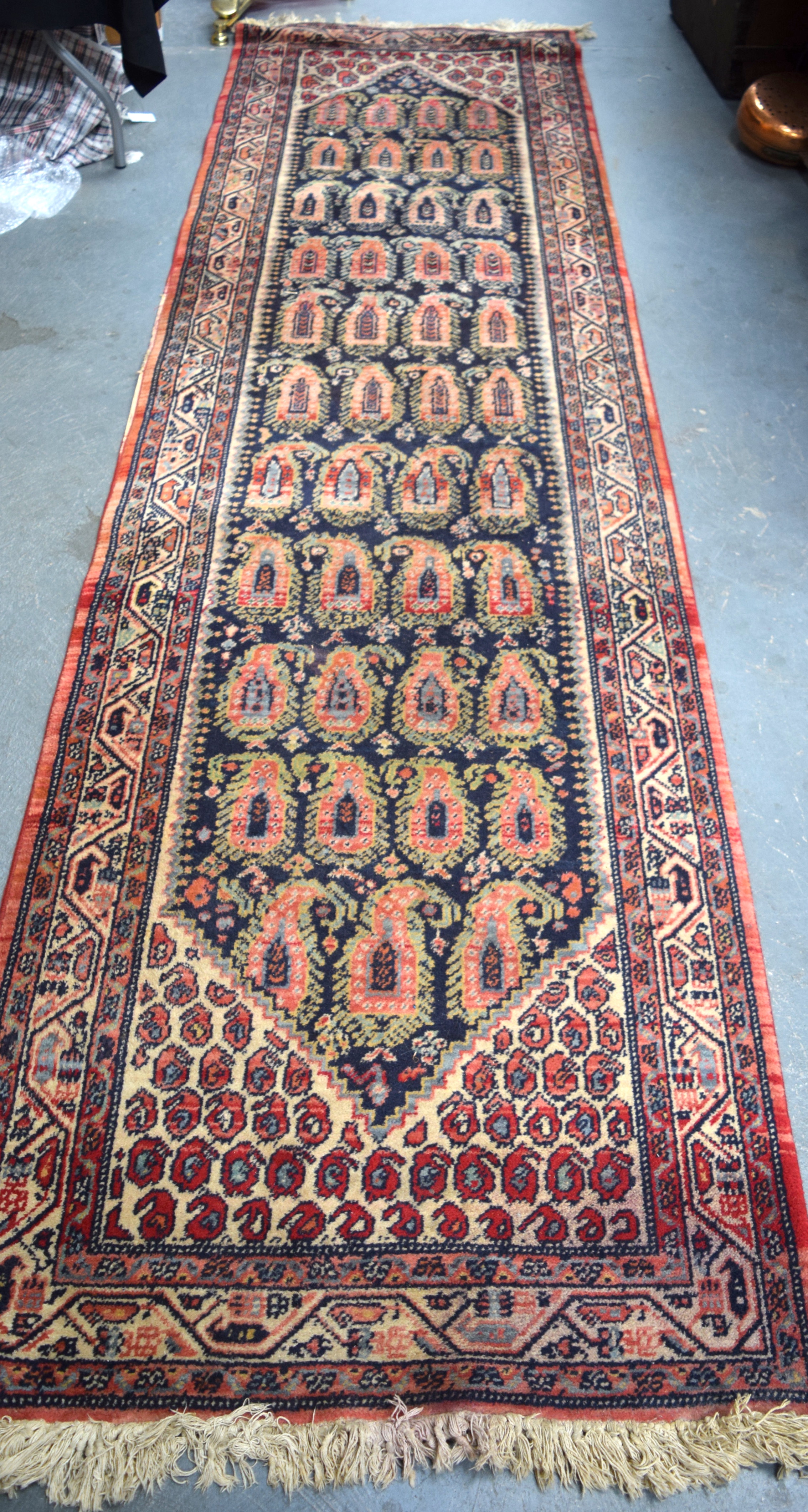 AN EARLY 20TH CENTURY PERSIAN RUNNER RUG, decorated with foliage and motifs. 330 cm x 90 cm.