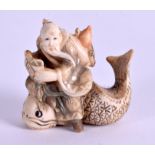 AN EARLY 20TH CENTURY JAPANESE MEIJI PERIOD IVORY NETSUKE modelled as a male upon a catfish. 4 cm x