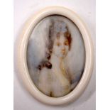 AN EARLY 20TH CENTURY IVORY PAINTED MINIATURE, depicting a female. 6.2 cm long.