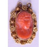 AN EARLY 20TH CENTURY YELLOW METAL CORAL INSET PENDANT, depicting a male portrait. 2.75 cm x 2 cm.