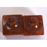 A PAIR OF CHINESE SHOUSHAN CARVED SEALS, decorated with a jovial buddha. 3 cm wide.