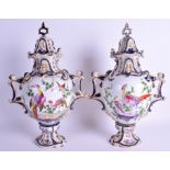 A PAIR OF 19TH CENTURY FRENCH PORCELAIN VASES AND COVERS painted with birds. 32 cm high.