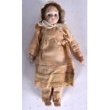 AN EARLY 20TH CENTURY BISQUE HEAD DOLL, formed in original clothing. 20 cm long.