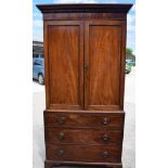 A GEORGIAN WOODEN CUPBOARD ON ON CHEST, formed with three long graduated drawers. 216 cm x 102 cm w