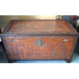 AN EARLY 20TH CENTURY CHINESE WOODEN TRUNK, carved with extensive landscape scenery and foliage. 59