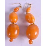 A PAIR OF AMBER BEAD EARRINGS. 7.5 cm long & weight 19 grams.