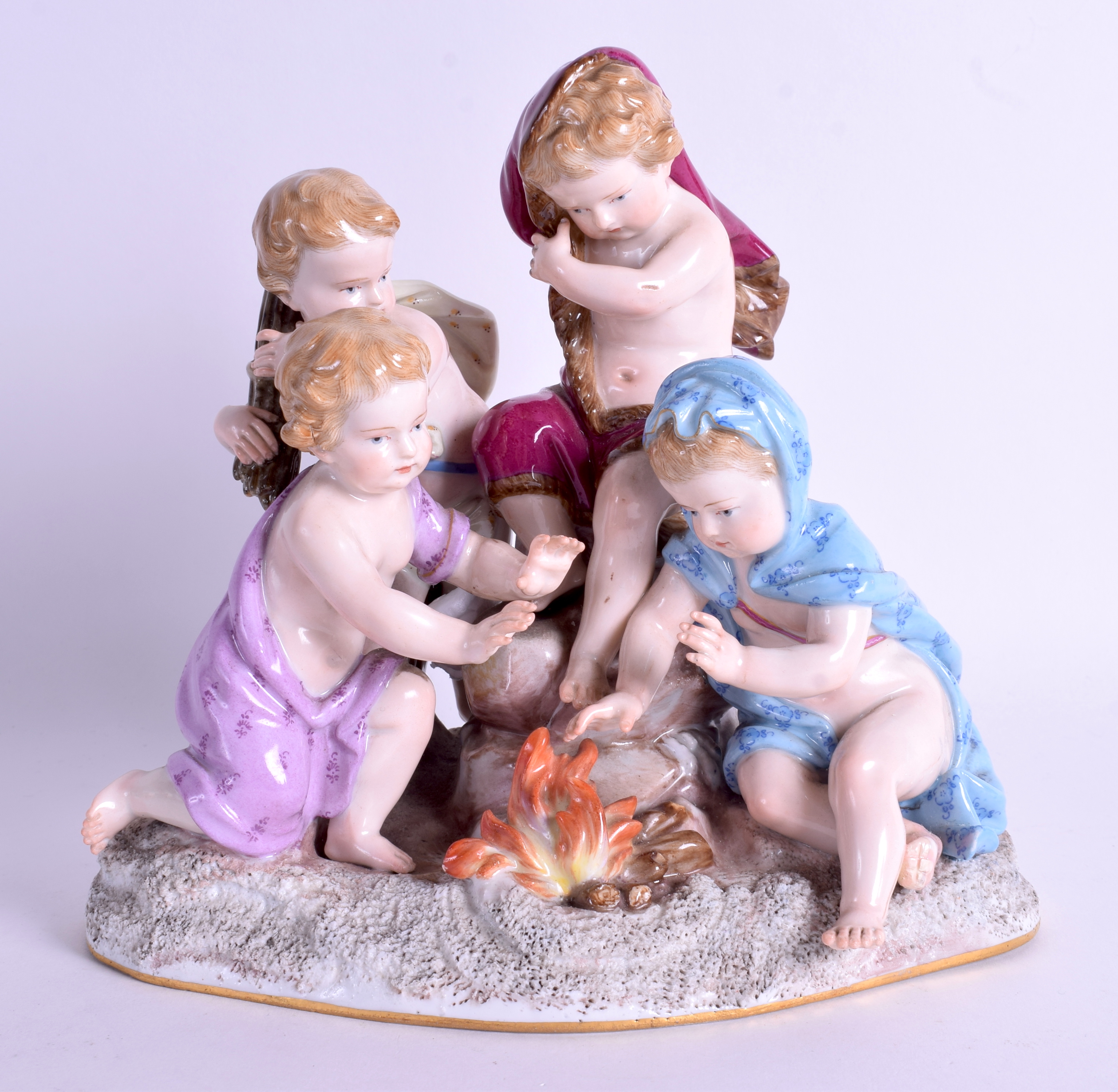 A 19TH CENTURY MEISSEN PORCELAIN FIGURE OF FOUR CHILDREN modelled beside a fire. 18 cm x 18 cm.