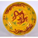 A CHINESE YELLOW GROUND PORCELAIN DISH BEARING CHENGHUA MARKS, painted with iron red five claw drag