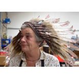 A RARE EARLY 20TH CENTURY NATIVE AMERICAN WAR BONNET, formed with eagle feathers and snake skin.