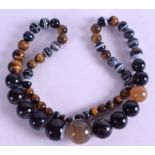 A TIGERS EYE AND AGATE BEAD NECKLACE, spherical in form. Largest bead 2.8 cm.
