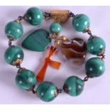 A VICTORIAN MALACHITE GOLD MOUNTED BRACELET, formed with a heart shaped agate pendant and a cross.