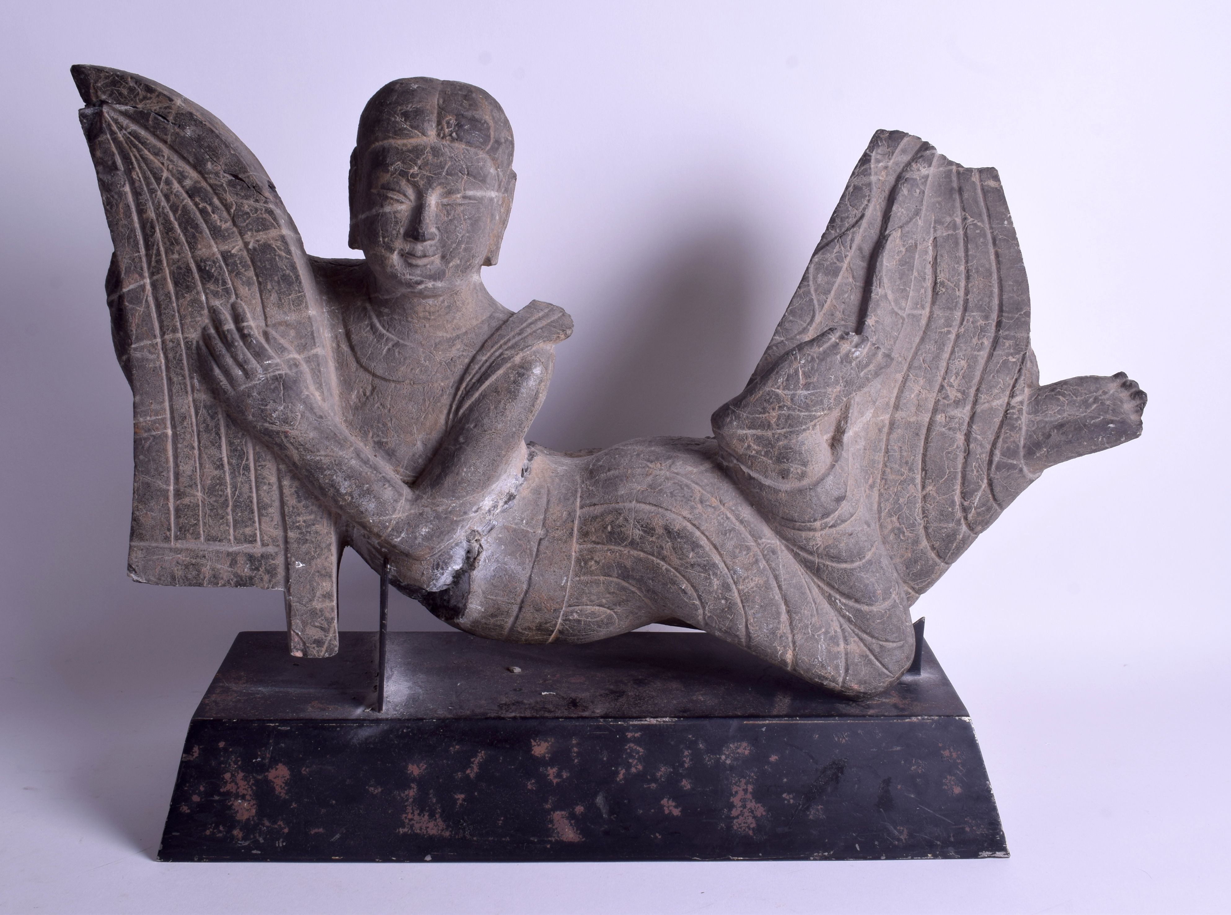 A VERY LARGE CENTRAL ASIAN STONE CARVING OF AN IMMORTAL modelled upon a plinth. Stone 60 cm x 32 cm