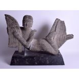 A VERY LARGE CENTRAL ASIAN STONE CARVING OF AN IMMORTAL modelled upon a plinth. Stone 60 cm x 32 cm