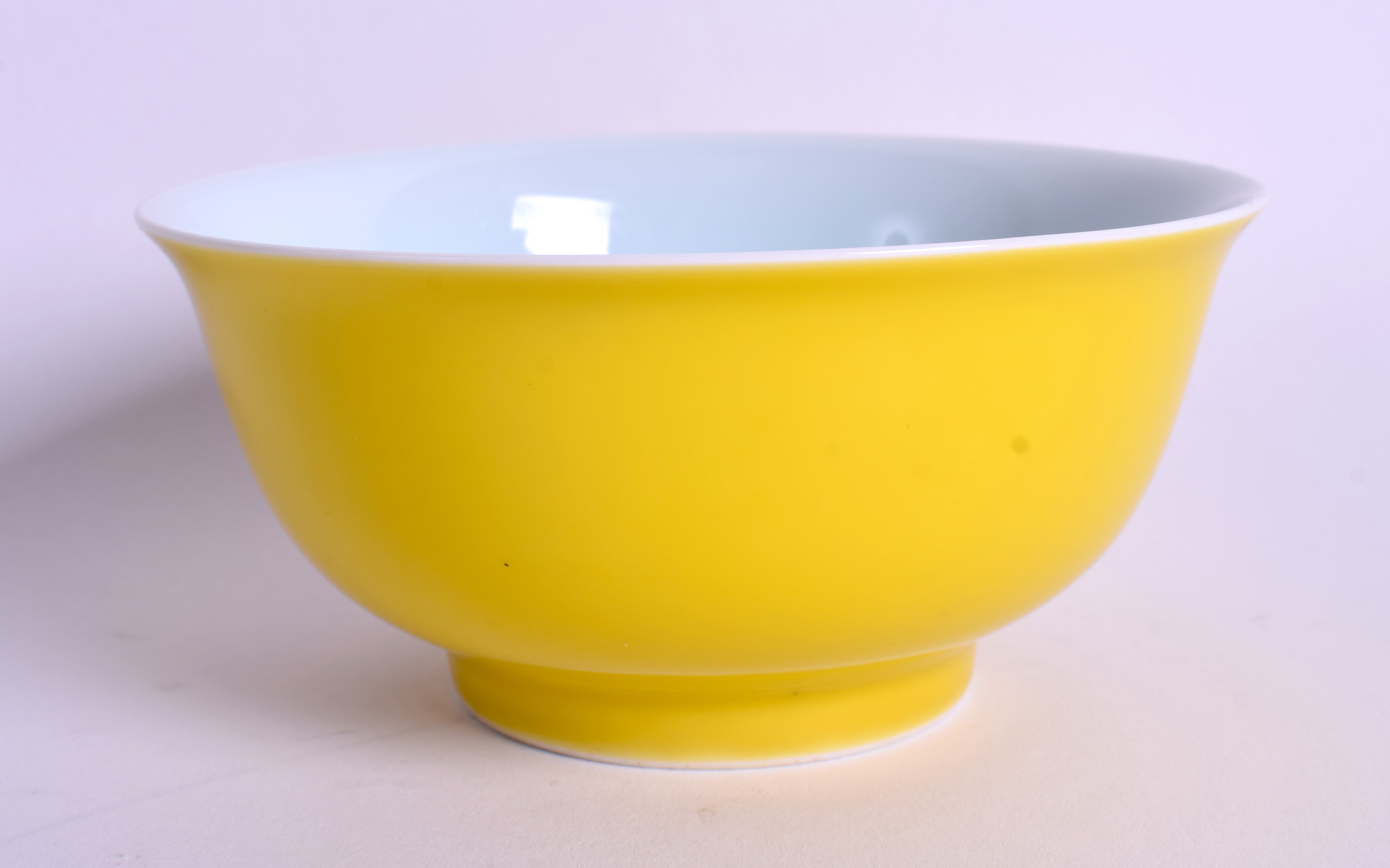 A CHINESE IMPERIAL YELLOW GROUND PORCELAIN BOWL bearing Kangxi marks to base. 11 cm wide.