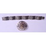A SILVER BRACELET and a silver brooch. (2)