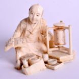 A 19TH CENTURY JAPANESE MEIJI PERIOD CARVED IVORY OKIMONO modelled as an artisan. 8 cm x 6 cm.