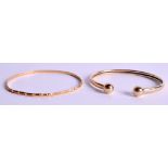 A 9CT GOLD BANGLE together with another yellow metal bangle. Gold 8.4 grams. (2)