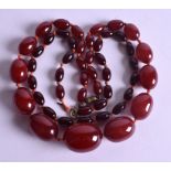 TWO CHERRY AMBER NECKLACES. 76 grams. (2)