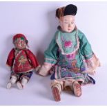 TWO EARLY 20TH CENTURY CHINESE SILKWORK PAPIER MACHE DOLLS each within embellished clothing. 52 cm
