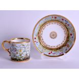 AN EARLY 19TH CENTUR FRENCH PARIS CUP AND SAUCER painted with flowers. (2)