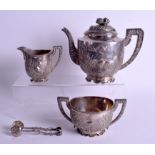 A 19TH CENTURY CHINESE FOUR PIECE SILVER TEASET by Wang Hing, decorated with birds and foliage. 141