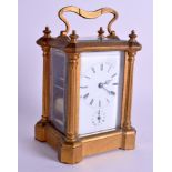 AN ANTIQUE FRENCH BRASS REPEATING CARRIAGE CLOCK with column supports. 16.25 cm high inc handle.