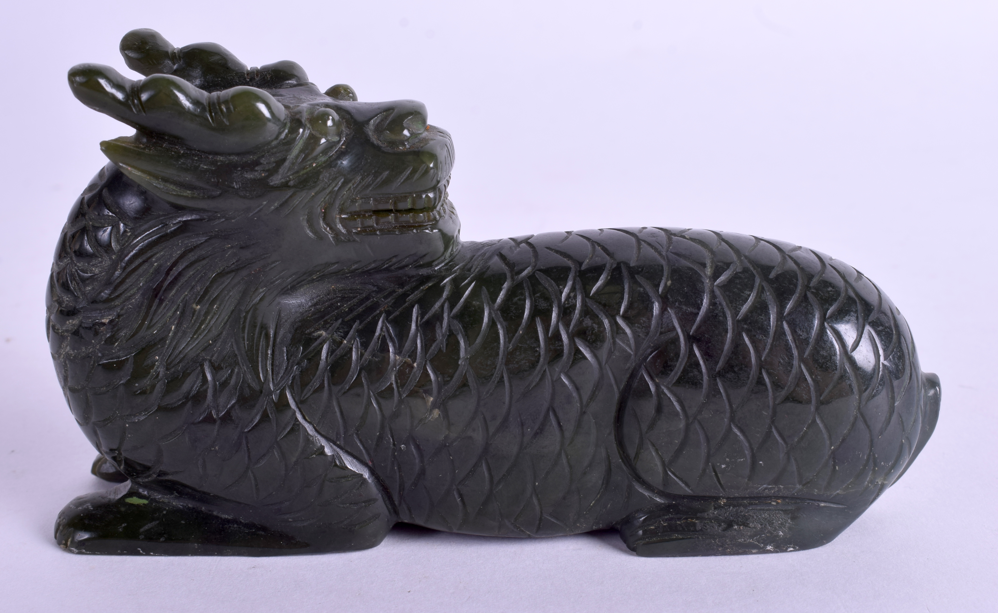 A CHINESE CARVED GREEN HARDSTONE BUDDHISTIC BEAST. 11 cm x 7 cm. - Image 2 of 3
