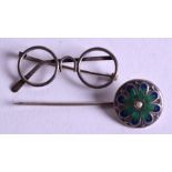 A SILVER AND ENAMEL BROOCH together with a silver spectacle brooch. (2)