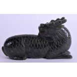 A CHINESE CARVED GREEN HARDSTONE BUDDHISTIC BEAST. 11 cm x 7 cm.