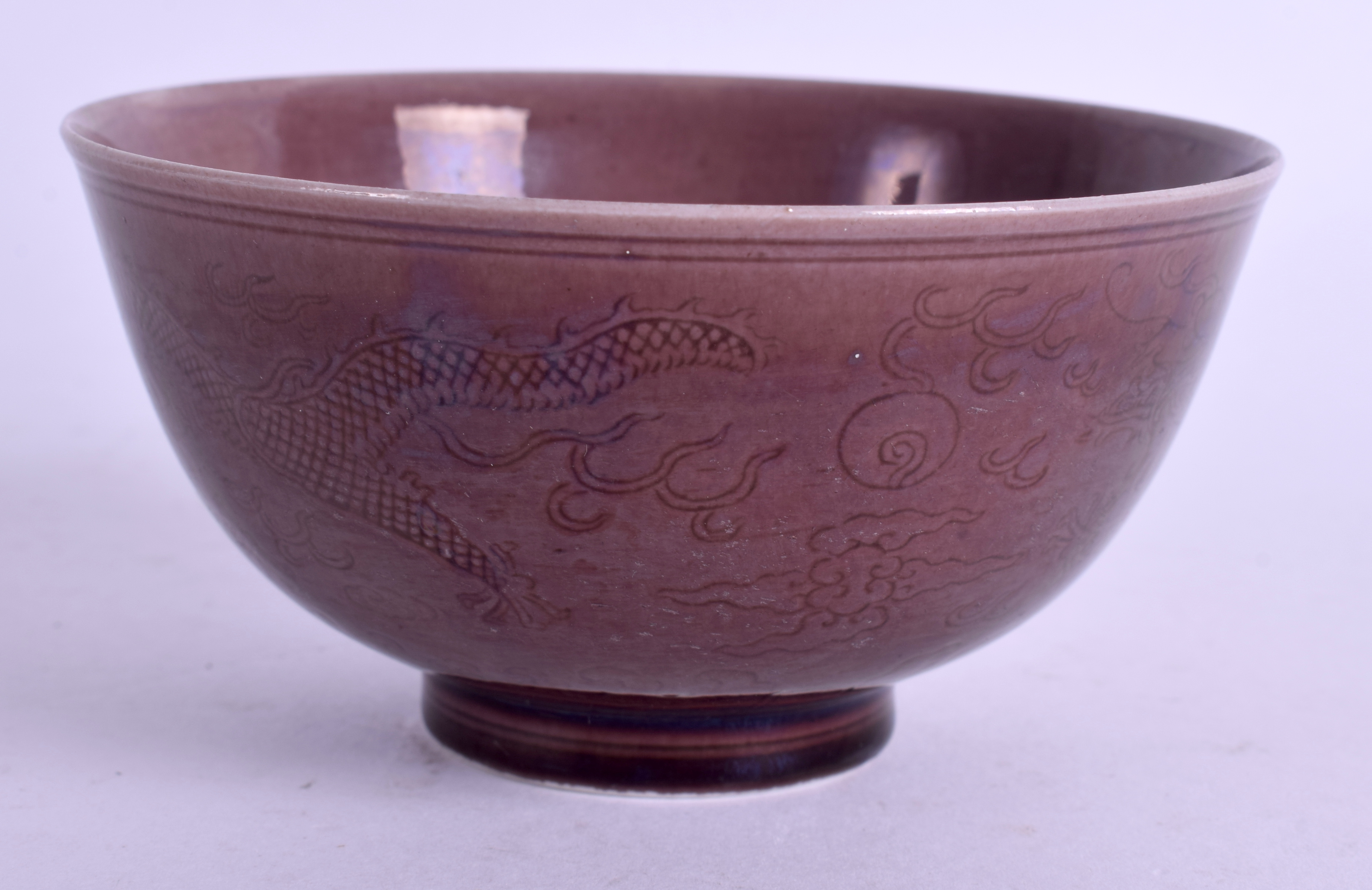 A CHINESE AUBERGINE GLAZED TEABOWL Guangxu mark and possibly of the period. 10 cm wide.