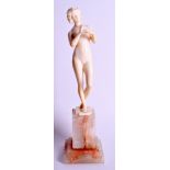 AN ART NOUVEAU EUROPEAN CARVED IVORY FIGURE OF A NUDE FEMALE modelled upon a onyx base. Ivory 18.5