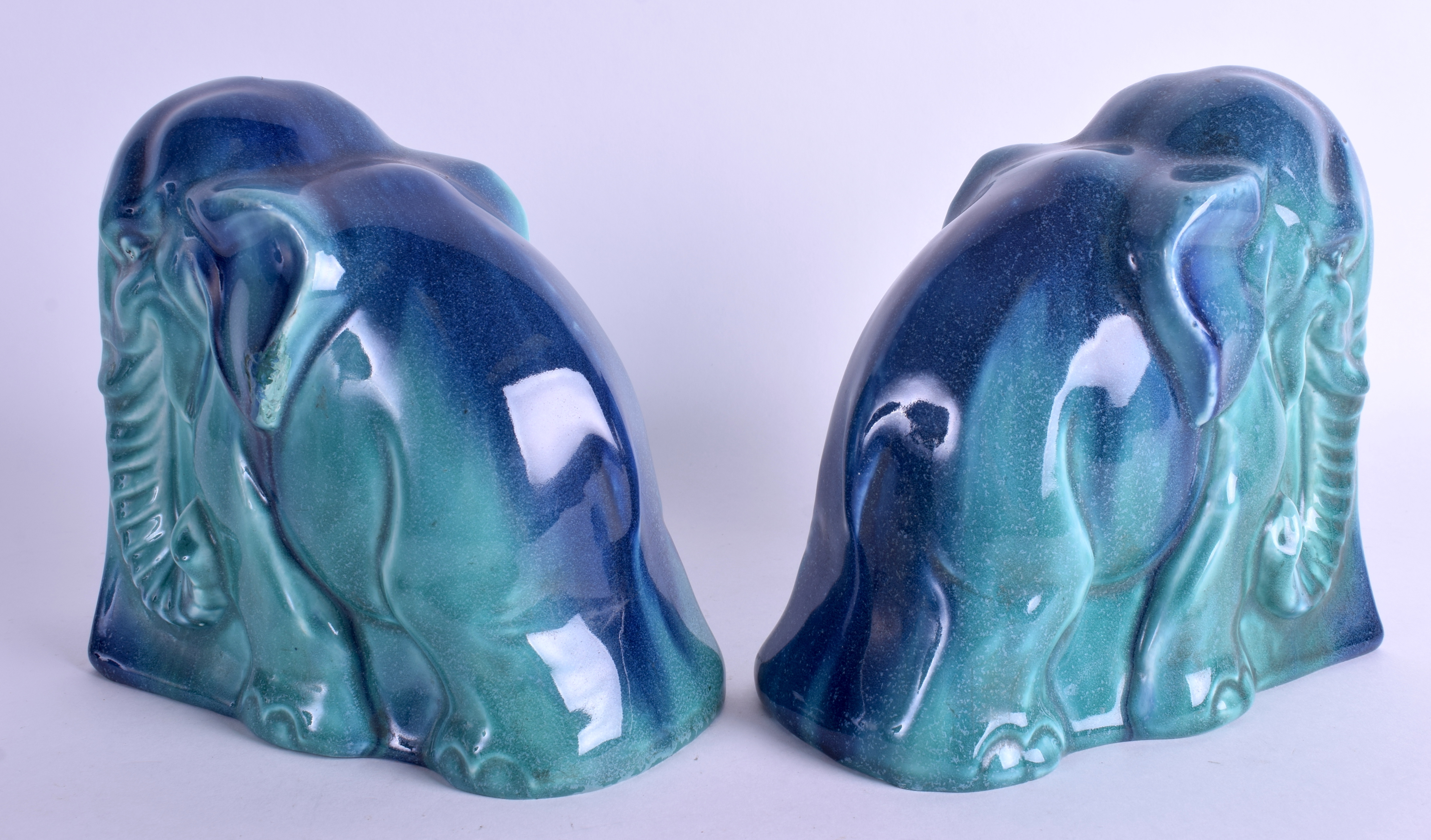 AN UNUSUAL PAIR OF 1950S CONTINENTAL BLUE GLAZED FLAMBE POTTERY BOOKENDS in the form of elephants. - Image 2 of 3