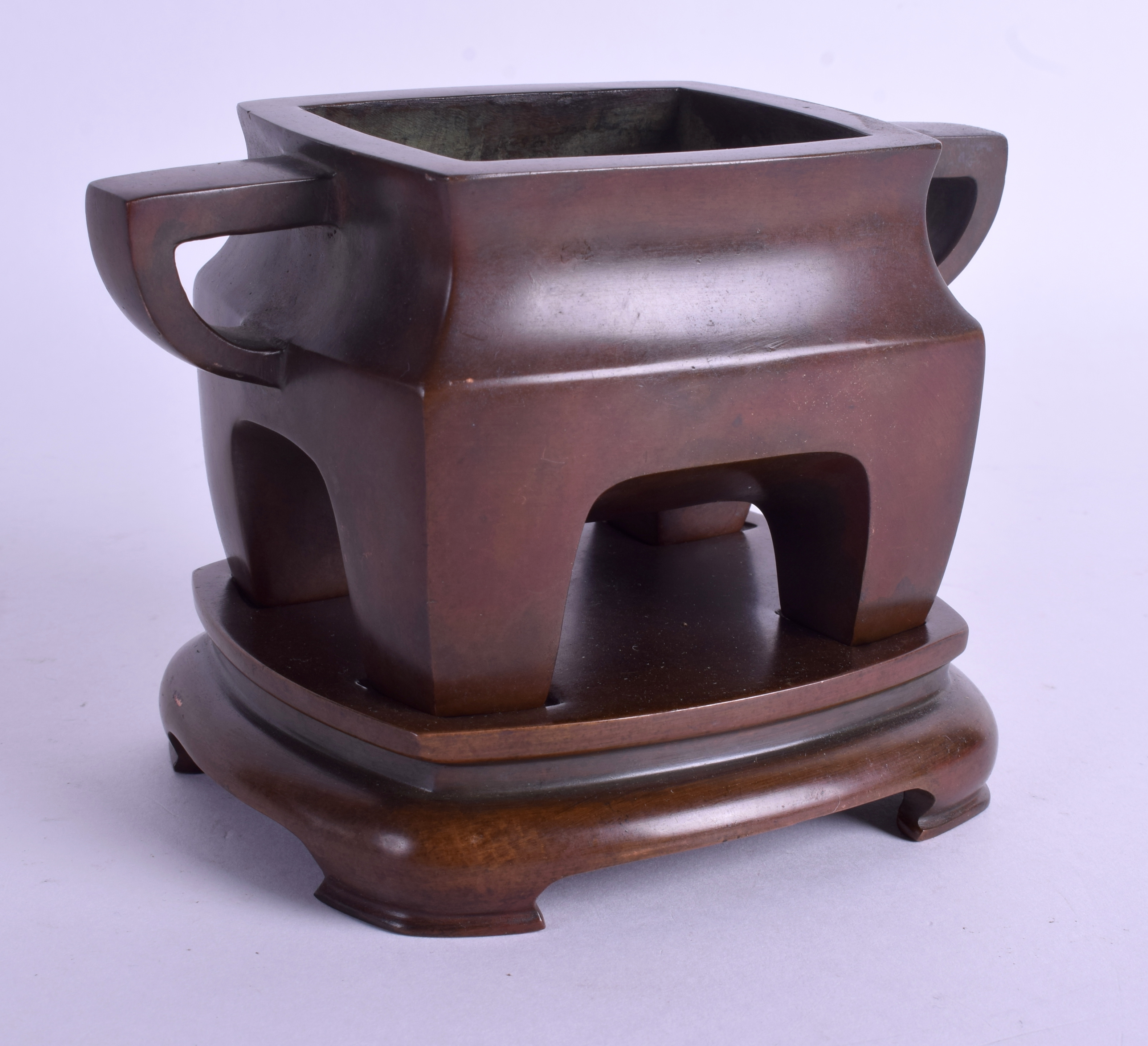 A CHINESE TWIN HANDLED BRONZE CENSER ON STAND. 15 cm wide, internal width 7 cm. (2)