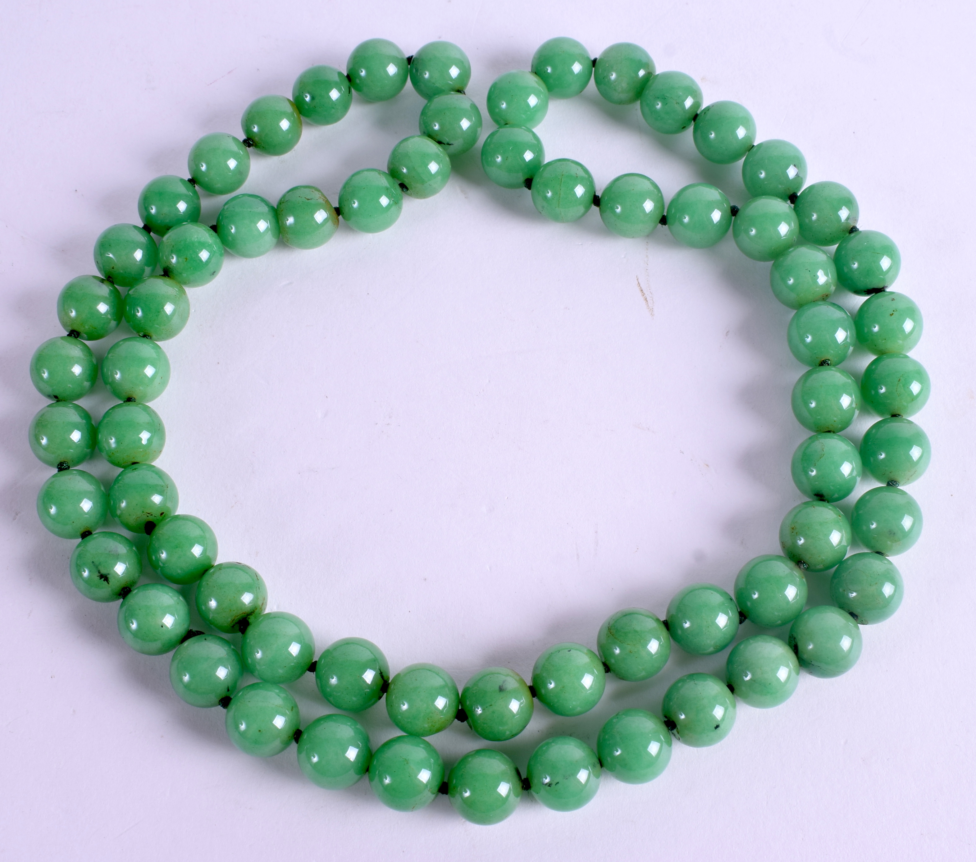 A CHINESE JADEITE NECKLACE. 80 cm long.
